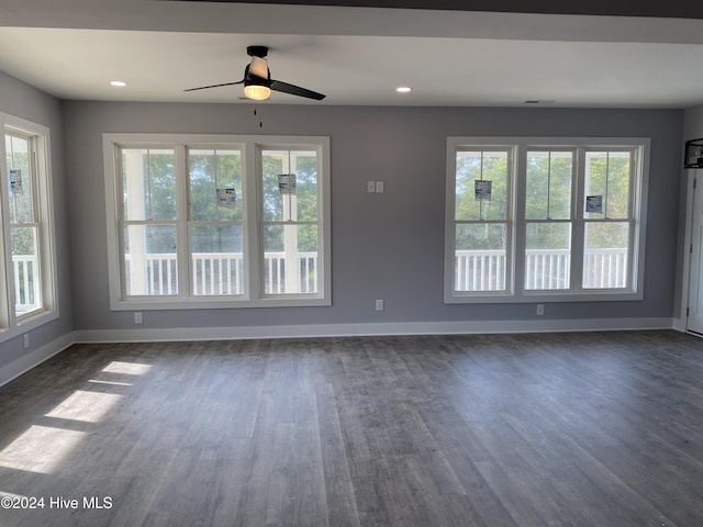 unfurnished room featuring ceiling fan and dark hardwood / wood-style flooring