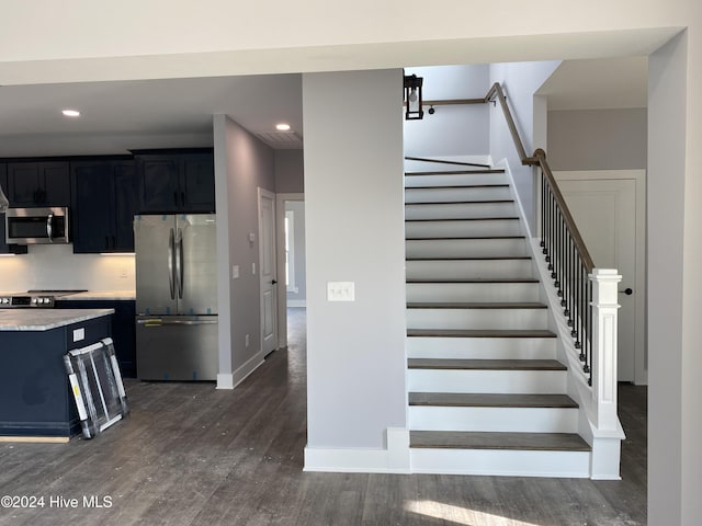 stairway featuring hardwood / wood-style flooring