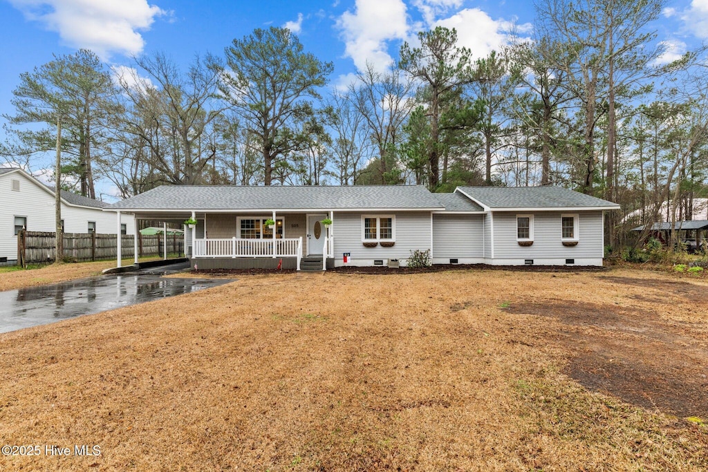 single story home with a carport, a porch, and a front yard