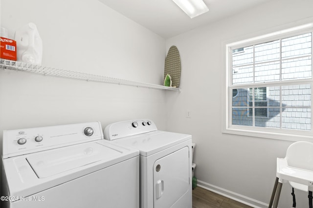 laundry area featuring washing machine and dryer and dark wood-type flooring