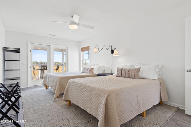 bedroom with access to exterior, ceiling fan, and hardwood / wood-style flooring