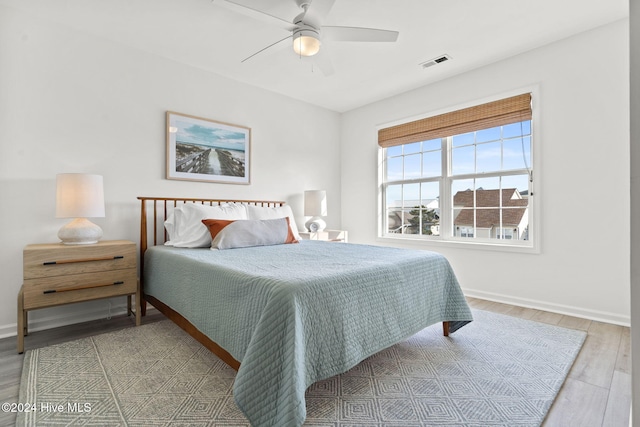 bedroom with wood-type flooring and ceiling fan