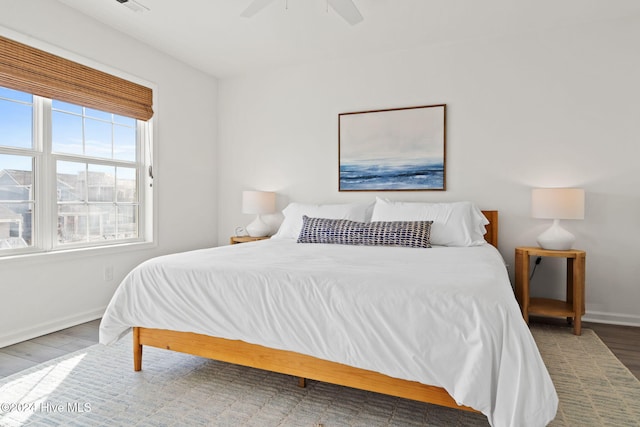 bedroom with hardwood / wood-style flooring and ceiling fan