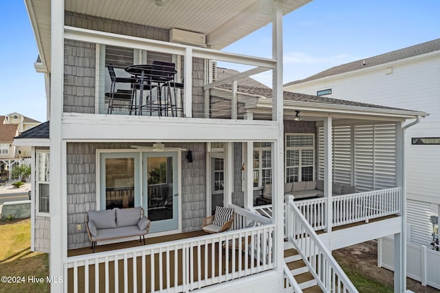 wooden deck featuring a sunroom