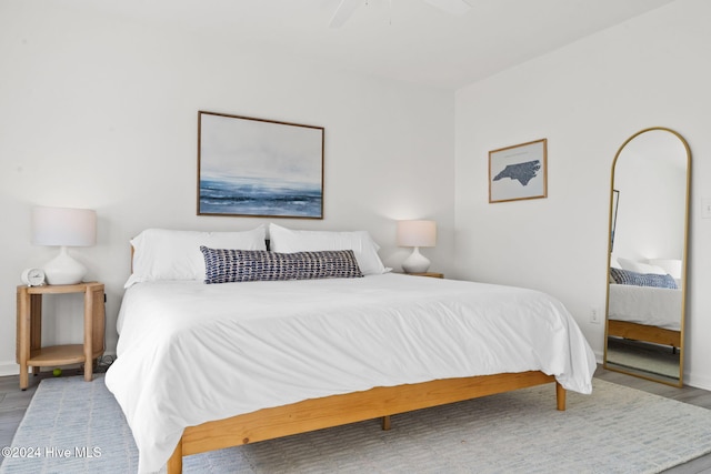 bedroom with ceiling fan and light hardwood / wood-style flooring