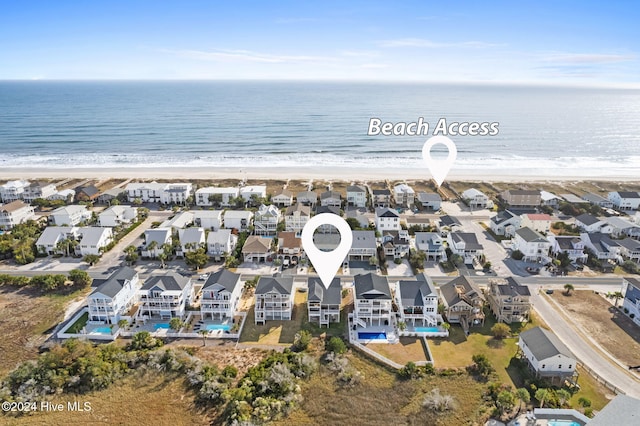 drone / aerial view featuring a water view and a view of the beach