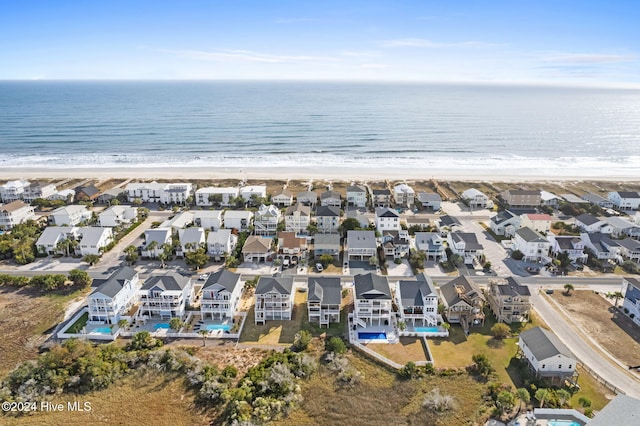 aerial view with a water view and a view of the beach