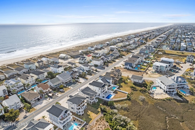 bird's eye view with a water view and a beach view