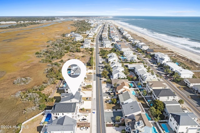 birds eye view of property featuring a water view and a view of the beach