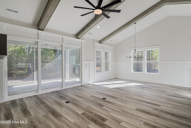 unfurnished room featuring wood-type flooring, ceiling fan with notable chandelier, and vaulted ceiling with beams