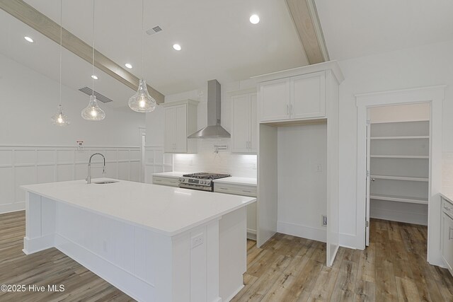 kitchen featuring dishwasher, light stone countertops, white cabinetry, and sink