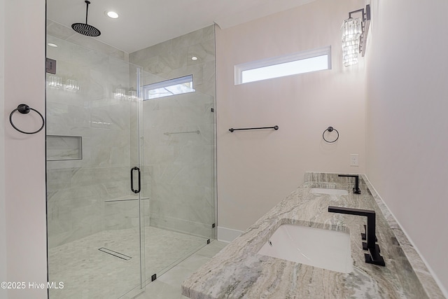 bathroom with vanity and a shower with door