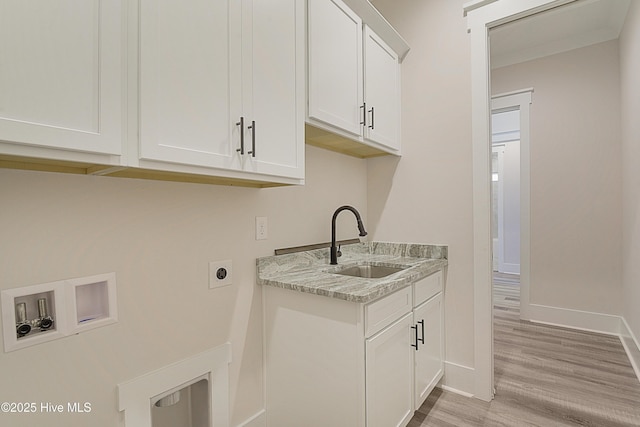 laundry room with electric dryer hookup, cabinets, sink, washer hookup, and light hardwood / wood-style floors