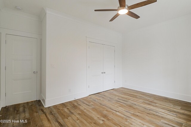 kitchen with light stone countertops, sink, white cabinets, and light hardwood / wood-style flooring