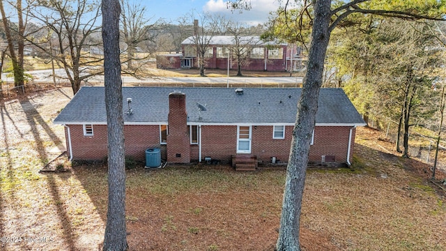 back of house with a lawn and central AC unit