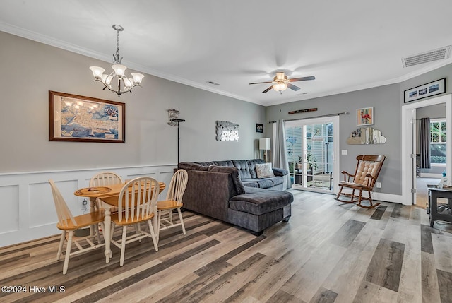 living room featuring crown molding, ceiling fan with notable chandelier, and light wood-type flooring