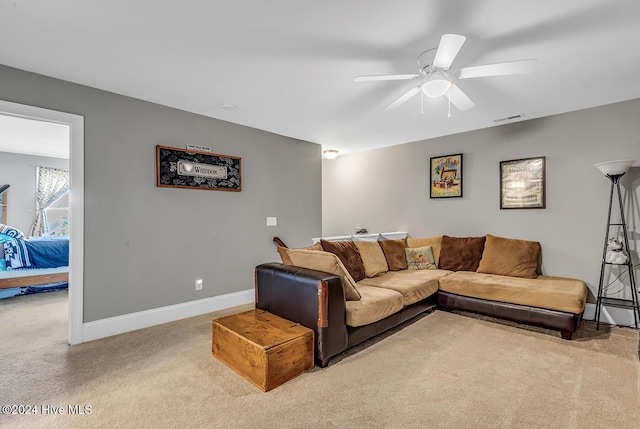 living room featuring light carpet, baseboards, visible vents, and ceiling fan