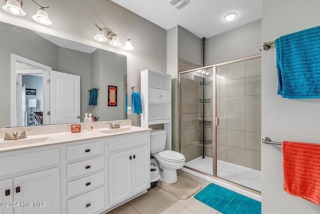 bathroom featuring a stall shower, visible vents, a sink, and tile patterned floors