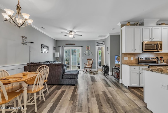 kitchen with visible vents, white cabinets, dark stone counters, appliances with stainless steel finishes, and open floor plan