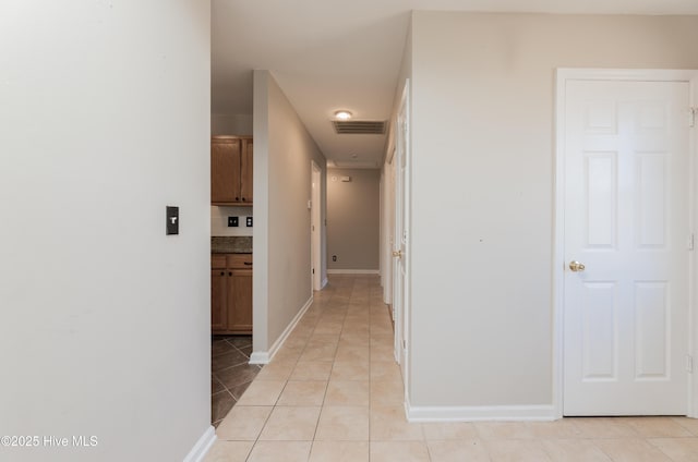 corridor with light tile patterned floors