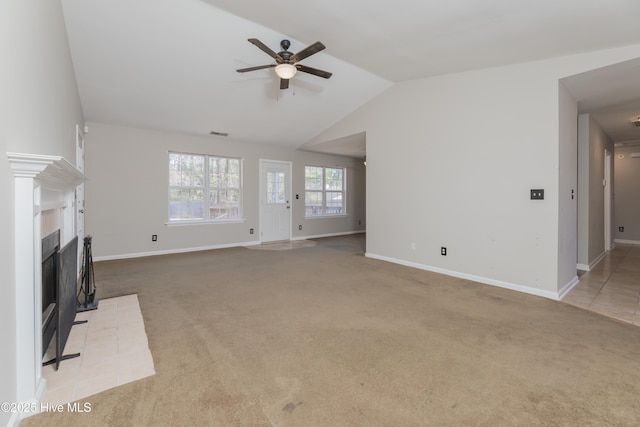 unfurnished living room featuring ceiling fan, lofted ceiling, light carpet, and a brick fireplace