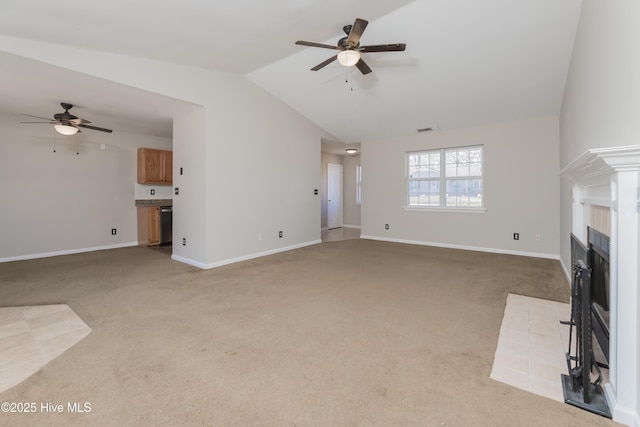 unfurnished living room featuring ceiling fan, light carpet, and vaulted ceiling