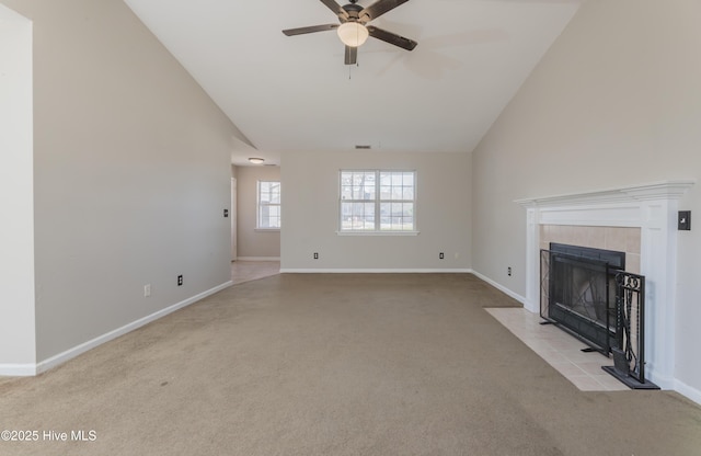 unfurnished living room with a tile fireplace, ceiling fan, light carpet, and lofted ceiling