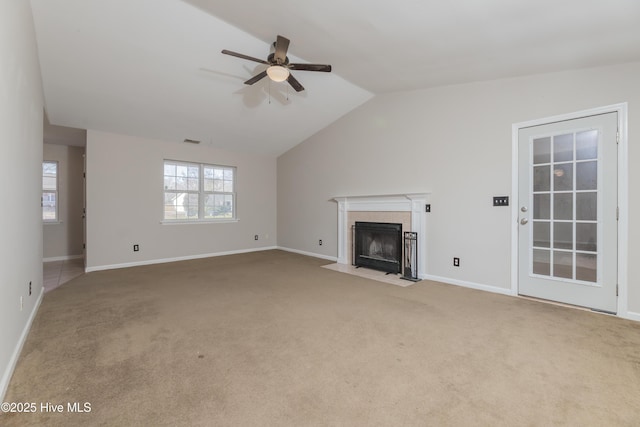 unfurnished living room featuring carpet flooring, a tile fireplace, ceiling fan, and lofted ceiling