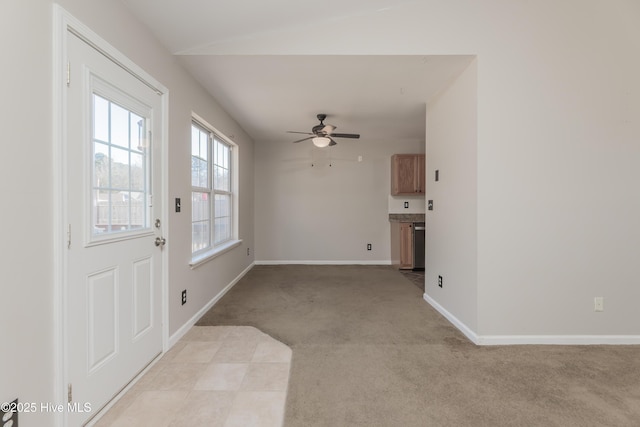 interior space with ceiling fan and light colored carpet