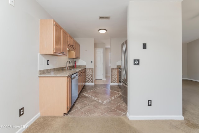 kitchen featuring light brown cabinetry, sink, light tile patterned flooring, and stainless steel appliances