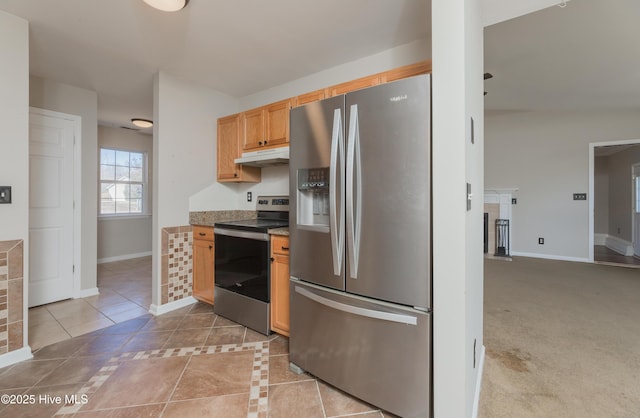 kitchen with light colored carpet and stainless steel appliances