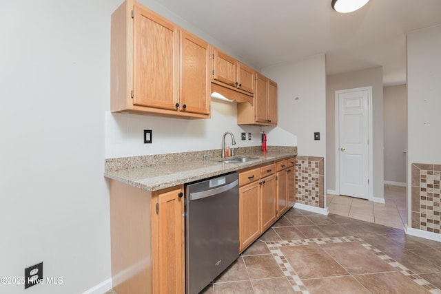 kitchen featuring tile patterned floors, light brown cabinets, stainless steel dishwasher, and sink