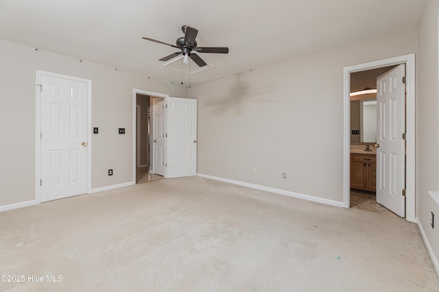 unfurnished bedroom with light carpet, ensuite bath, ceiling fan, and sink