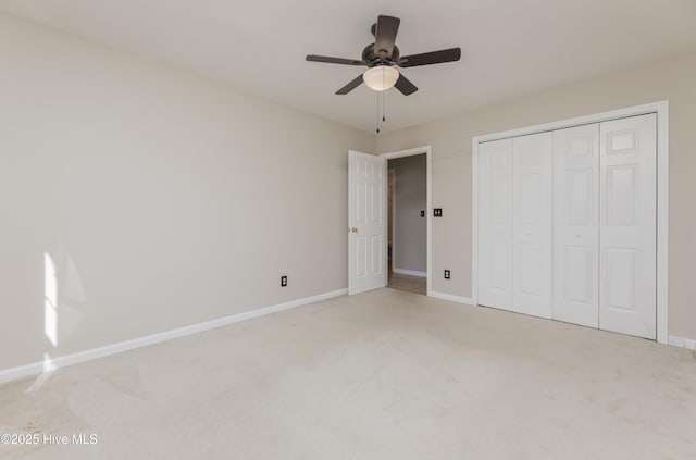 unfurnished bedroom with light carpet, a closet, and ceiling fan