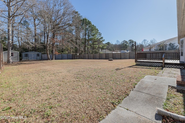 view of yard featuring a shed and a deck