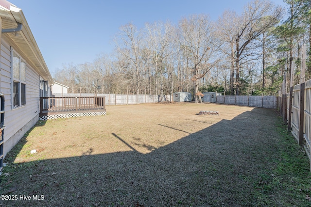 view of yard with a storage shed and a wooden deck