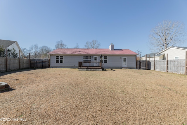 rear view of property featuring a wooden deck