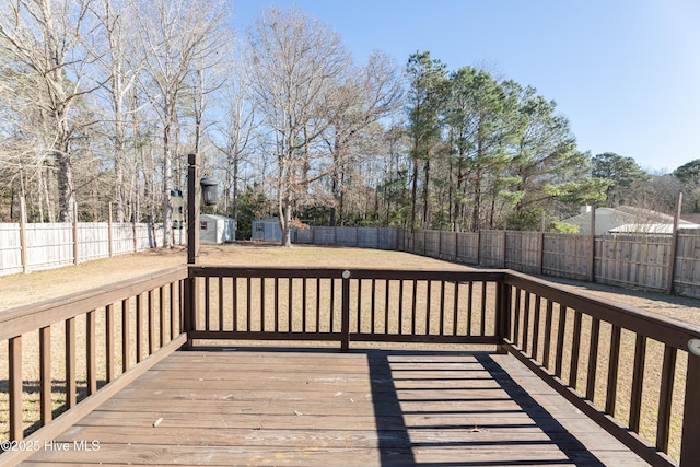 wooden terrace with a shed