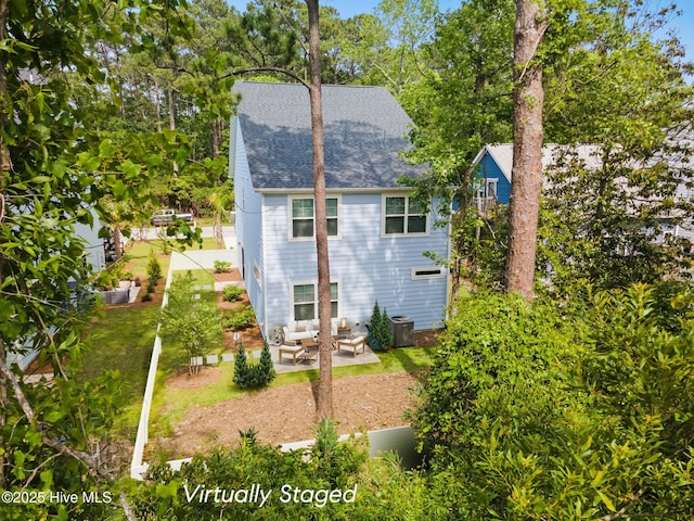 1163 N Caswell Ave, Southport, NC 28461 - rear view of house featuring a shingled roof, a patio area, and an outdoor hangout area