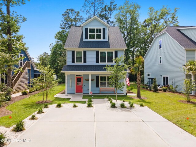 1163 N Caswell Ave, Southport, NC 28461 - view of front of home featuring a porch, a front yard, and a shingled roof