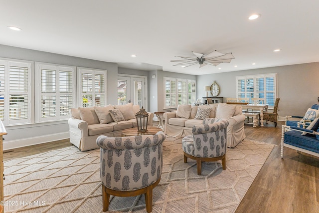 living room with recessed lighting, ceiling fan, baseboards, and wood finished floors