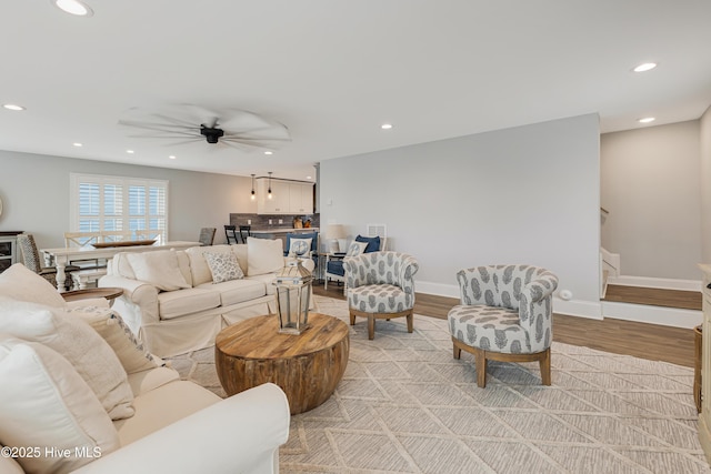 living room featuring ceiling fan and light wood-type flooring