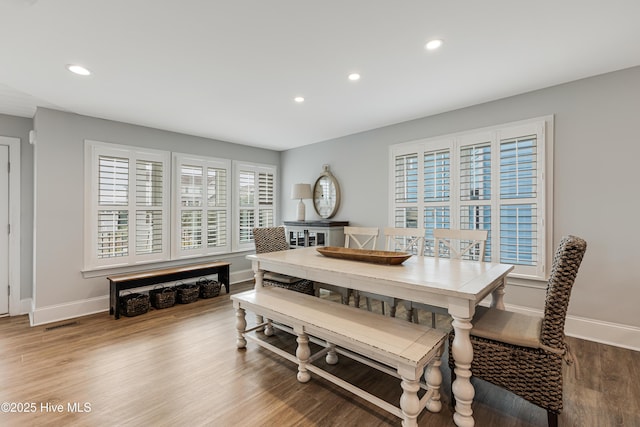 dining space featuring a healthy amount of sunlight and hardwood / wood-style flooring