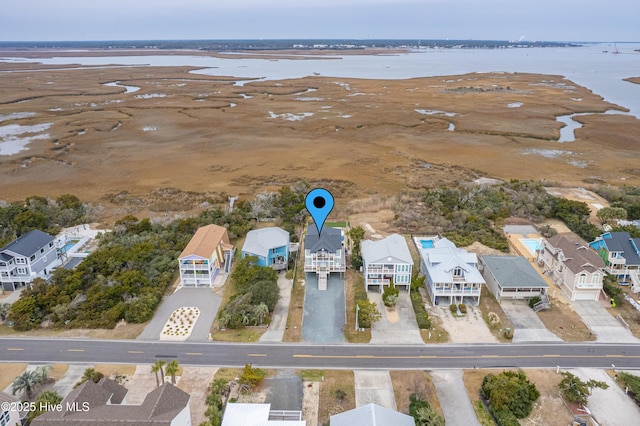 birds eye view of property with a water view and a residential view