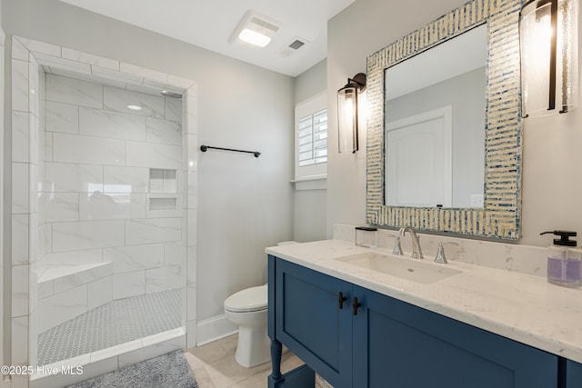 full bathroom featuring visible vents, toilet, a tile shower, vanity, and tile patterned floors