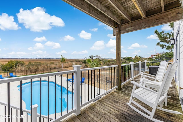 wooden deck featuring fence and a fenced in pool