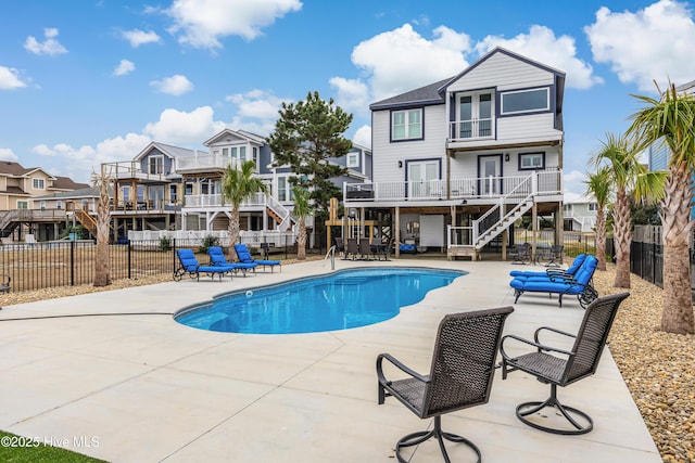 view of pool featuring fence, stairway, a residential view, a fenced in pool, and a patio area