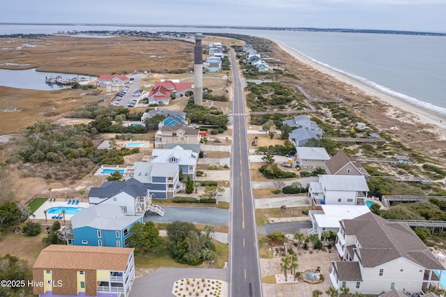 bird's eye view with a water view, a residential view, and a beach view