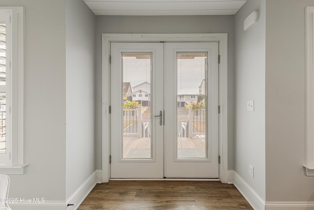 entryway with baseboards, wood finished floors, and french doors