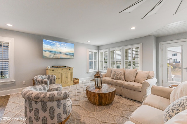 living room featuring light wood-style floors, recessed lighting, and baseboards